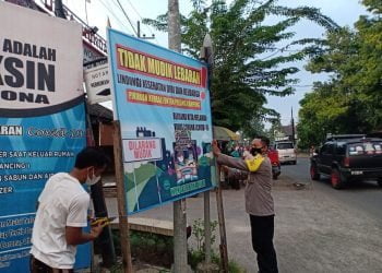 Polsek Pesantren Dampingi Relawan Jaga Posko PPKM Mikro